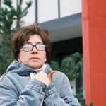 Waist-up portrait of mature woman on city street in cold weather